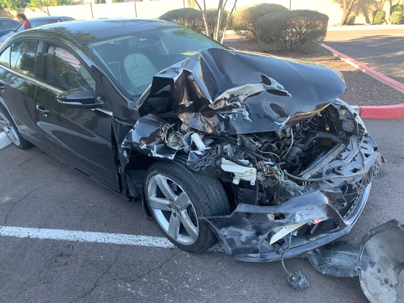 Black sedan with severe front-end crash damage purchased in Phoenix, Arizona
