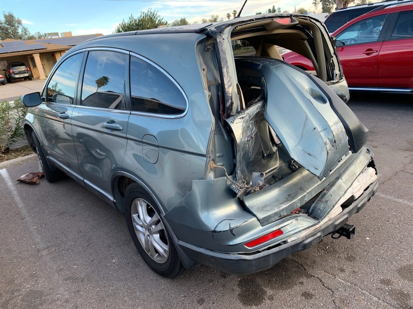 SUV with rear-end damage picked up from a Phoenix driveway for cash