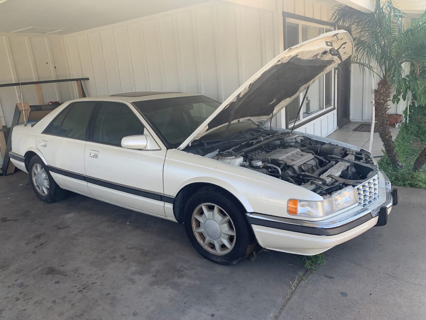 White sedan with the hood open that would not start, bought for cash in Phoenix