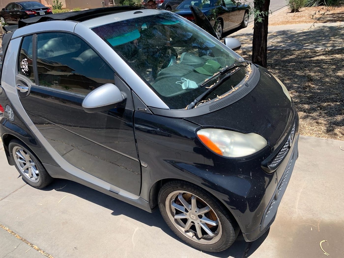 Small car parked for a long time in a Phoenix driveway before being sold for cash