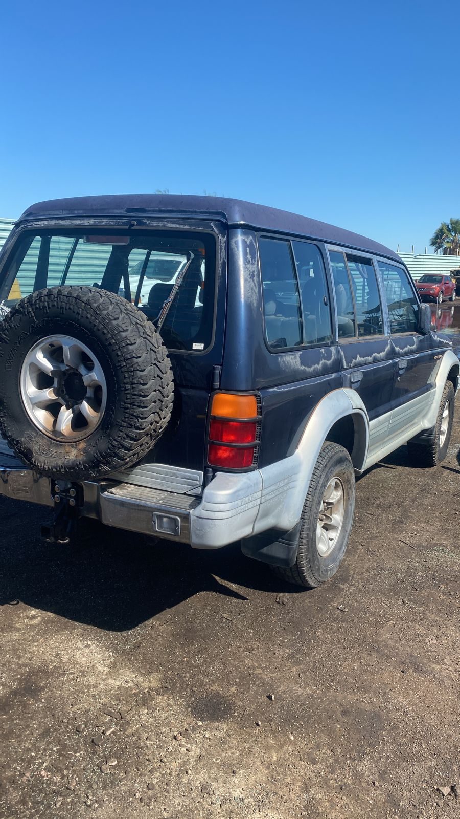 Older SUV with a spare tire on the back bought for cash in the Phoenix area